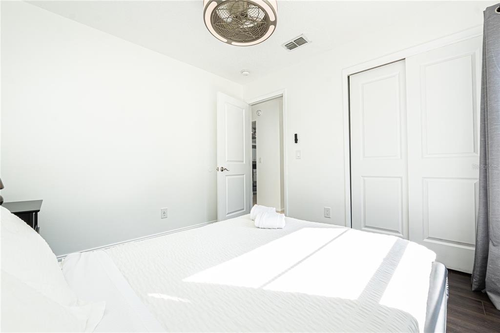 7720 Indian Ridge Trail South Kissimmee, FL 34747 - Photo 20 of 35 a bedroom with a bed and a table