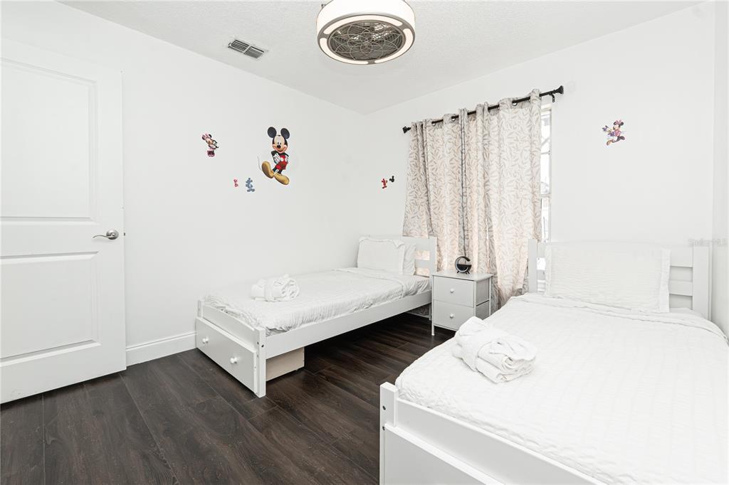 7720 Indian Ridge Trail South Kissimmee, FL 34747 - Photo 23 of 35 a bedroom with a bed and a window