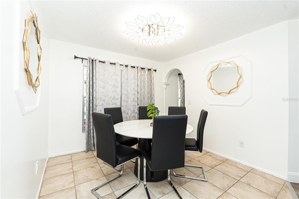7720 Indian Ridge Trail South Kissimmee, FL 34747 - Photo 8 of 35 a view of a dining room with furniture and wooden floor