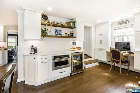 a kitchen with stainless steel appliances a stove a sink and a refrigerator