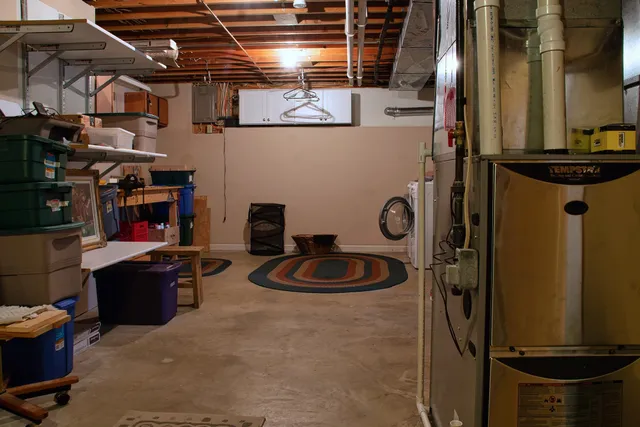 a kitchen with a refrigerator and a stove top oven