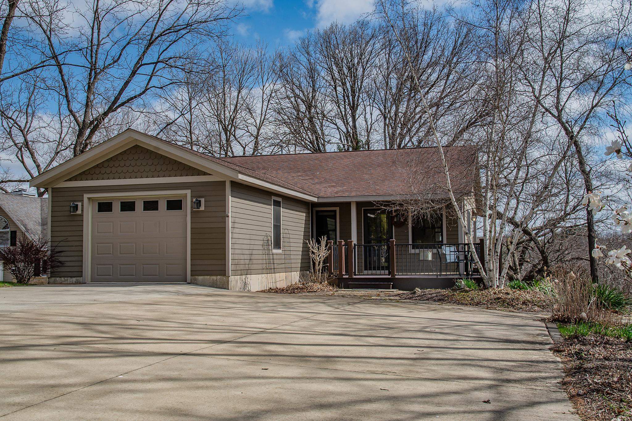 7-a252 Tomahawk Lane Apple River, IL 61001 - Photo 5 of 34 a front view of a house with a garden
