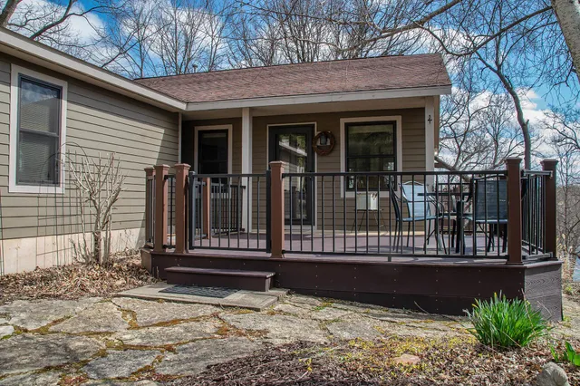 a view of a house with a window and wooden fence