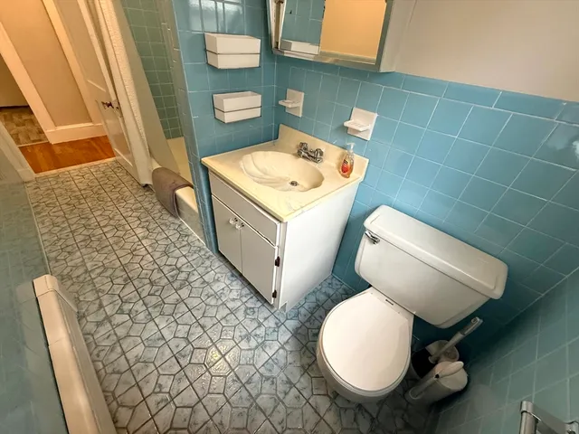 a bathroom with a toilet a sink and bathtub