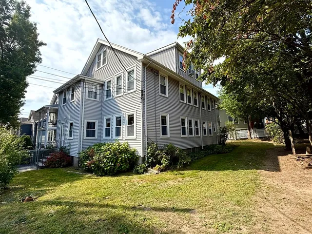 a view of a house with a yard