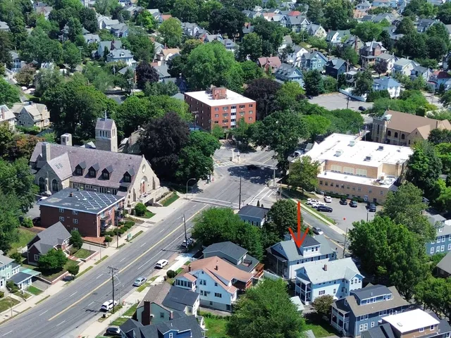 an aerial view of residential houses with outdoor space