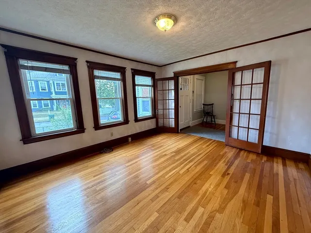 wooden floor in an empty room with a window