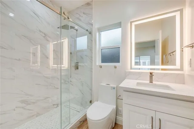 a bathroom with a sink toilet and shower