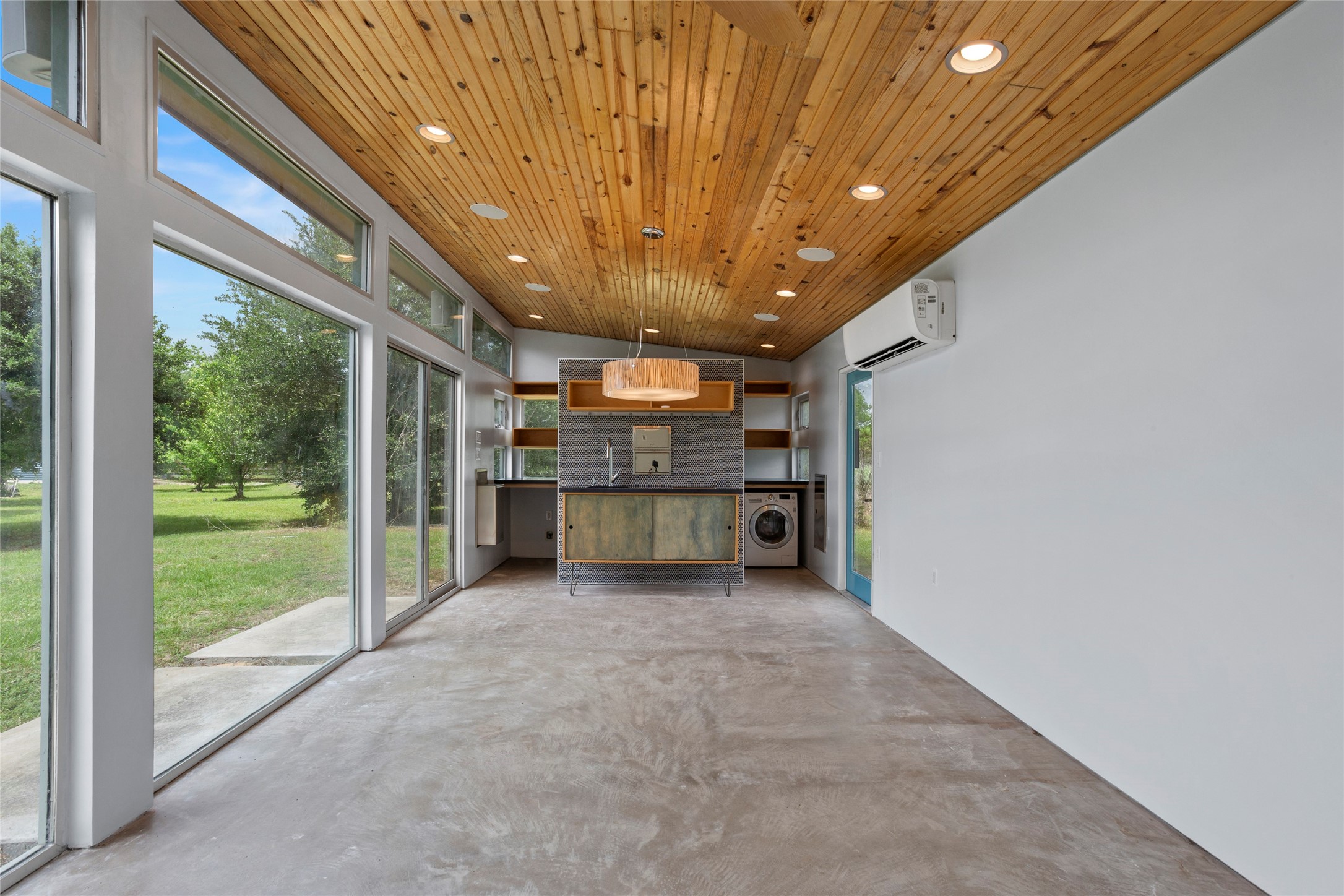 3650 Rivers Road Pearland, TX 77578 - Photo 6 of 22 Interior living quarters with sustainable eco-friendly beetle-kill pine ceiling, surround sound speakers, Kichenette, LG washer/dryer combo, bathroom with shower.