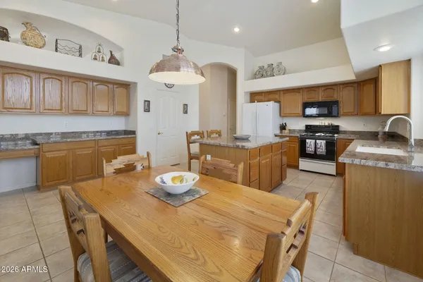 a kitchen with a dining table and chairs