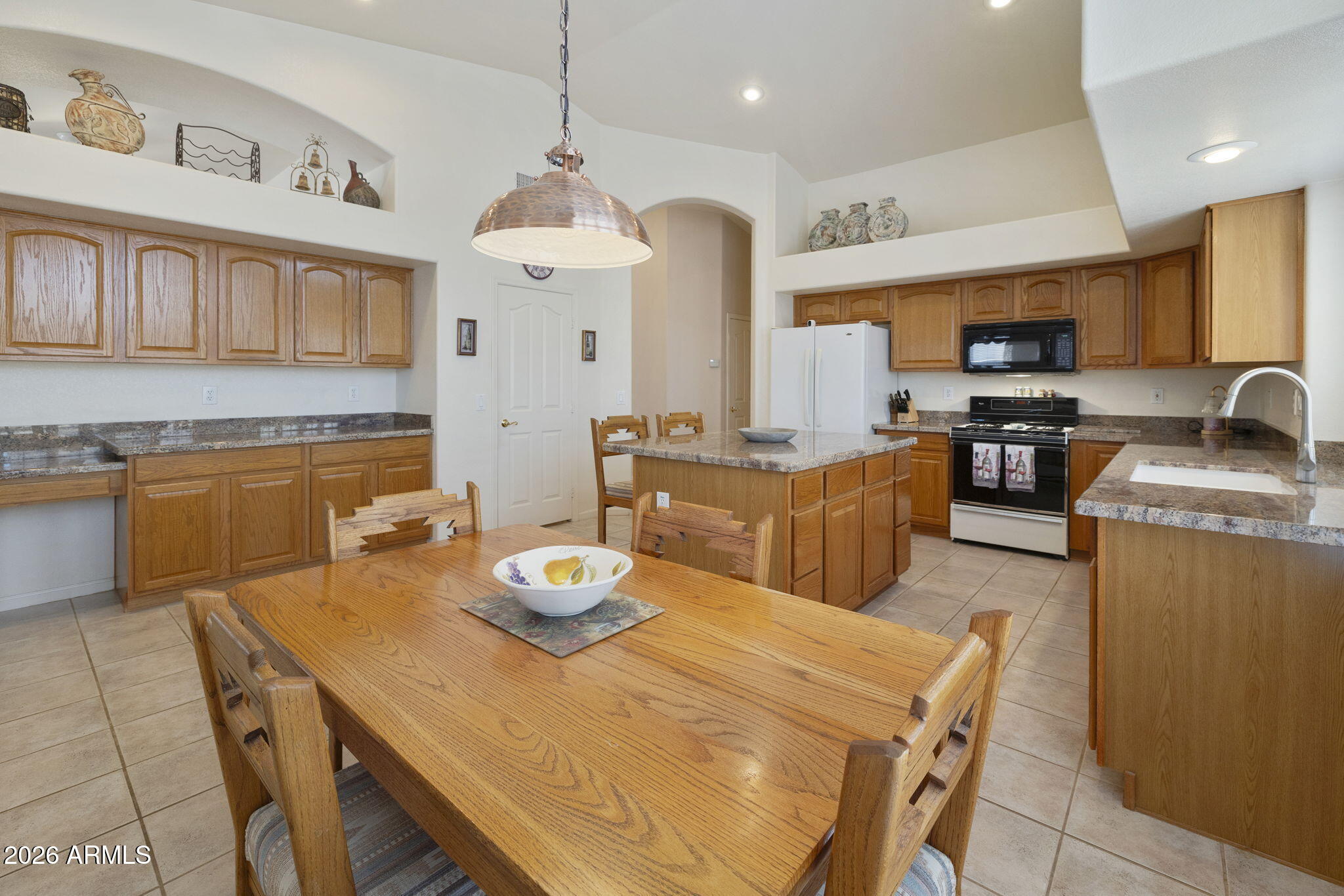 12435 West Monte Vista Road Avondale, AZ 85392 - Photo 1 of 69 a kitchen with a dining table and chairs