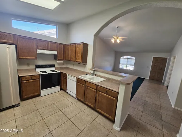 a kitchen with stainless steel appliances granite countertop a sink stove and refrigerator