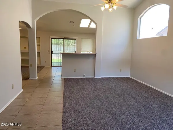 an empty room with a bathroom and a mirror