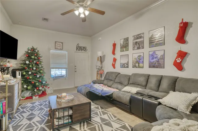 a living room with furniture and a flat screen tv