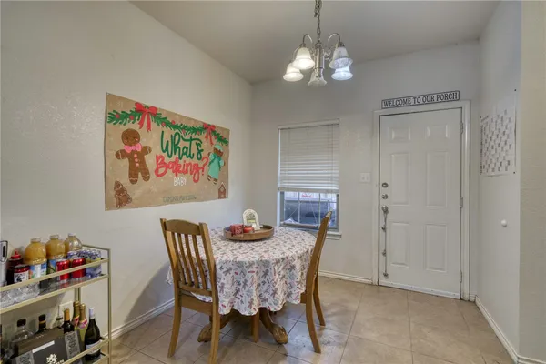 a view of a dining room with furniture and chandelier