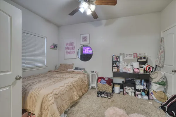 a bed room with a bed mirror and a window