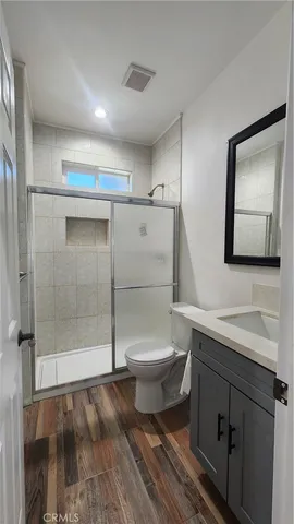 a view of a hallway with wooden floor and closet