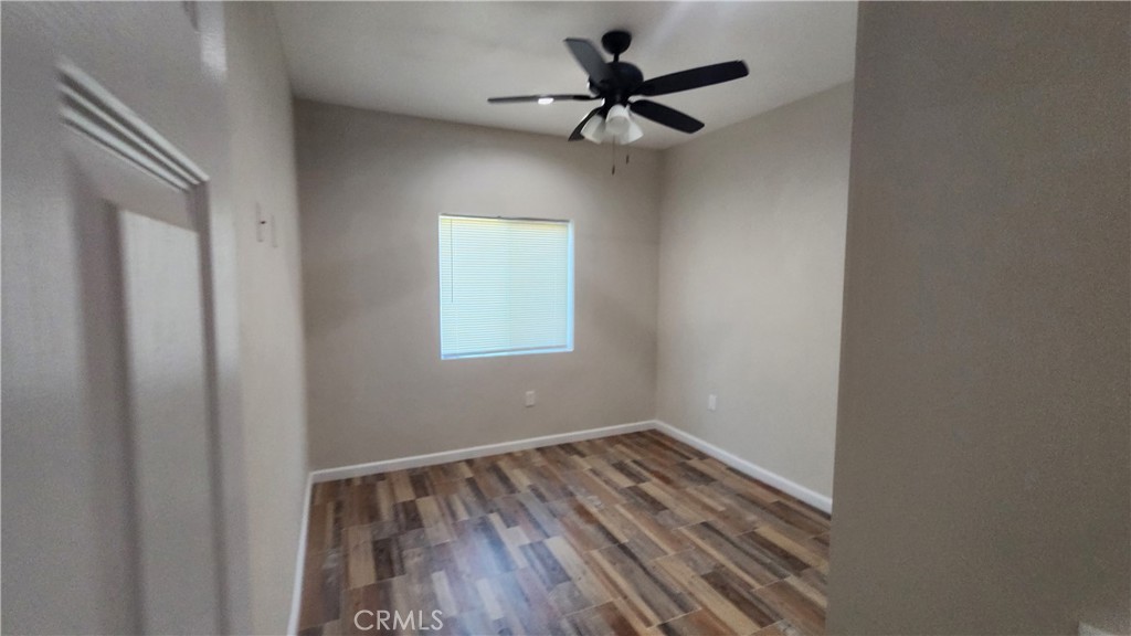 3433 Eucalyptus Avenue Riverside, CA 92507 - Photo 18 of 38 a view of room with hardwood floor and a ceiling fan