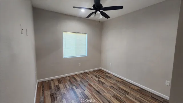 an empty room with a ceiling fan
