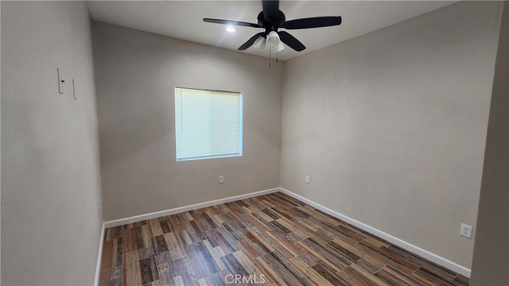 3433 Eucalyptus Avenue Riverside, CA 92507 - Photo 19 of 38 a view of a room with wooden floor and fan
