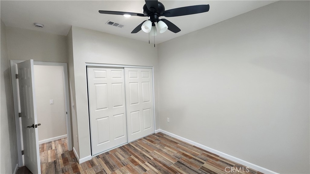 3433 Eucalyptus Avenue Riverside, CA 92507 - Photo 22 of 38 a view of room with hardwood floor and ceiling fan