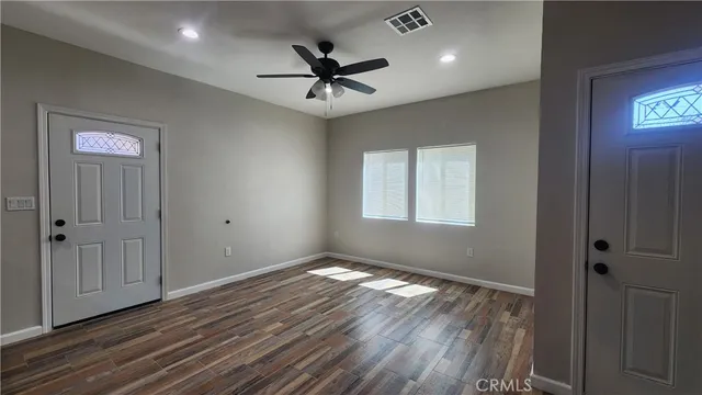 a kitchen with a refrigerator and a stove top oven