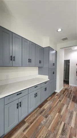 a kitchen with sink cabinets and wooden floor