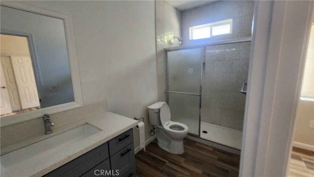 3433 Eucalyptus Avenue Riverside, CA 92507 - Photo 9 of 38 a bathroom with a granite countertop sink toilet a mirror and shower