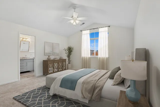 a bedroom with a large bed and a chandelier