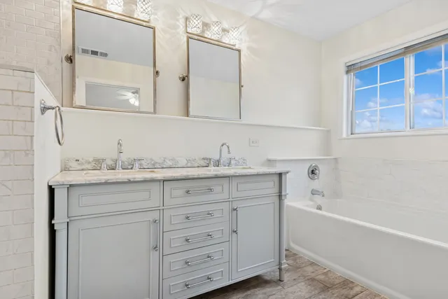 a bathroom with a granite countertop sink mirror and