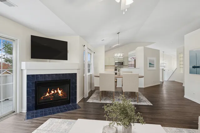 a living room with furniture a fireplace and a flat screen tv