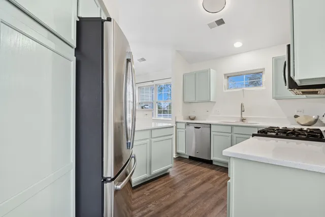 a kitchen with a sink stove and cabinets