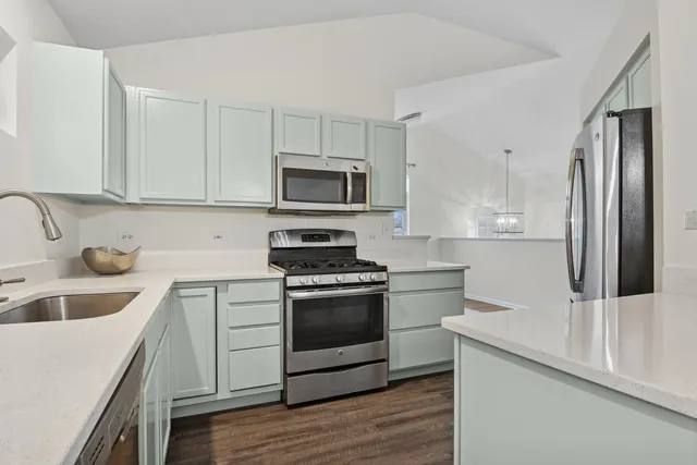 a kitchen with a sink stove and refrigerator