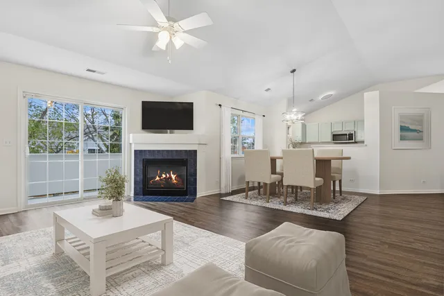 a living room with furniture a fireplace and a flat screen tv
