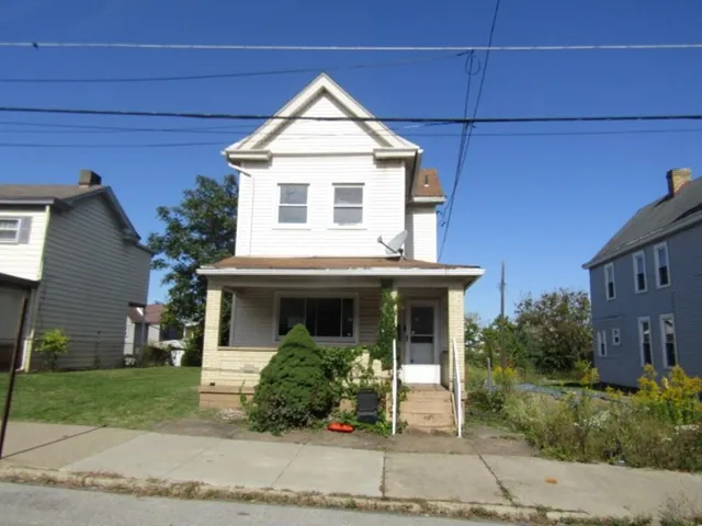 a view of a house with a yard and table and chairs