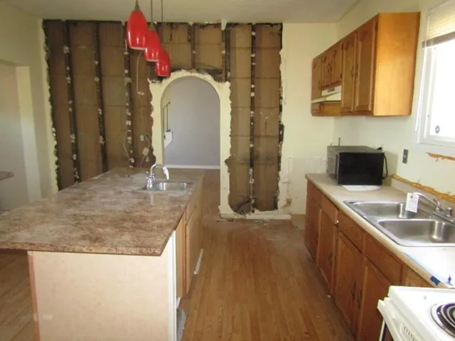 a bathroom with a granite countertop sink a toilet and a mirror