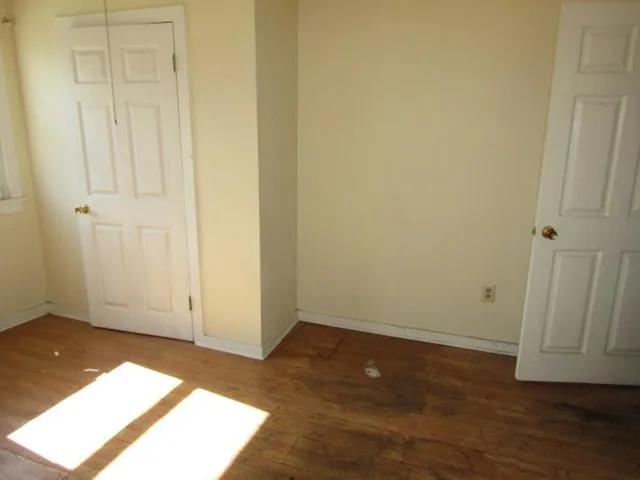 an empty room with wooden floor