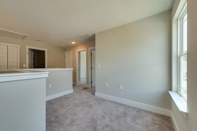 a view of a kitchen with white cabinets