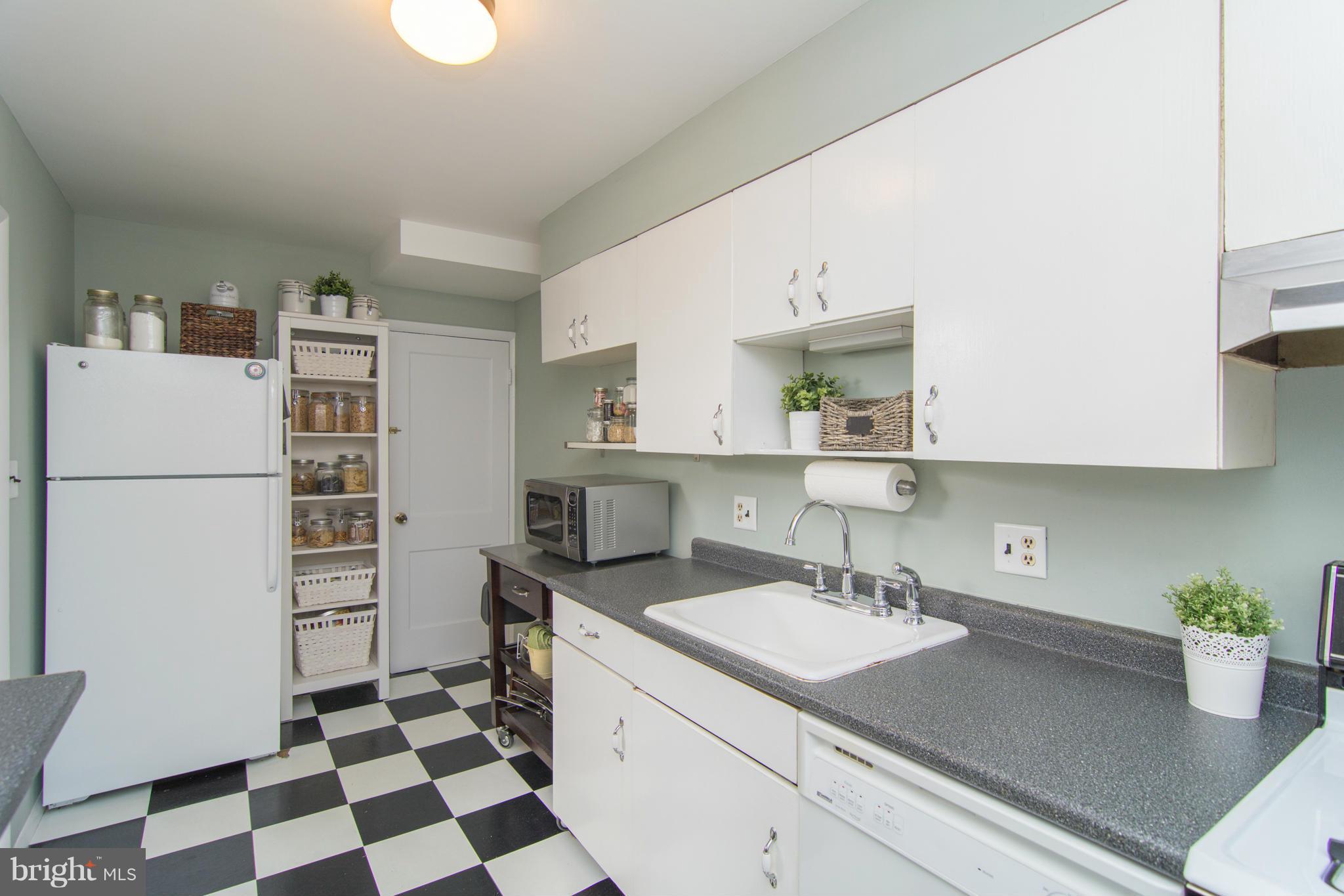 1642 Aberdeen Road Baltimore, MD 21286 - Photo 14 of 25 a kitchen with a sink a refrigerator and cabinets
