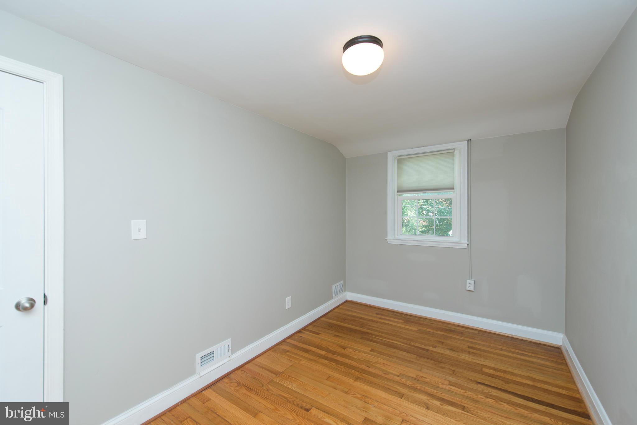 1642 Aberdeen Road Baltimore, MD 21286 - Photo 22 of 25 an empty room with wooden floor and windows