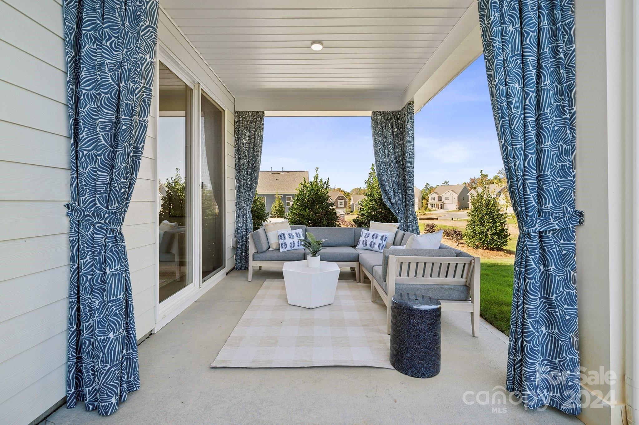 1410 Hubert Graham Way Tega Cay, SC 29708 - Photo 27 of 28 a view of a porch with dining area and garden view