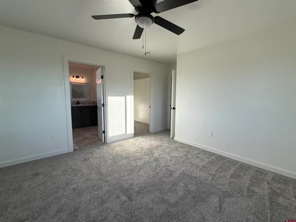 an empty room with closet and windows