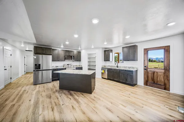 an empty room with a window and a fan