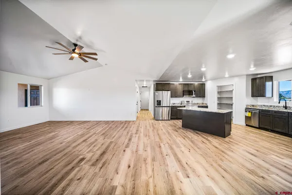 an empty room and chandelier fan in a room