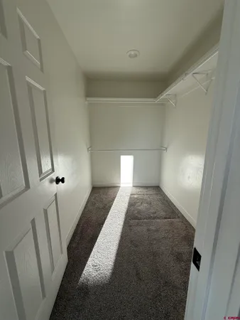 a bathroom with a granite countertop toilet a sink and a mirror