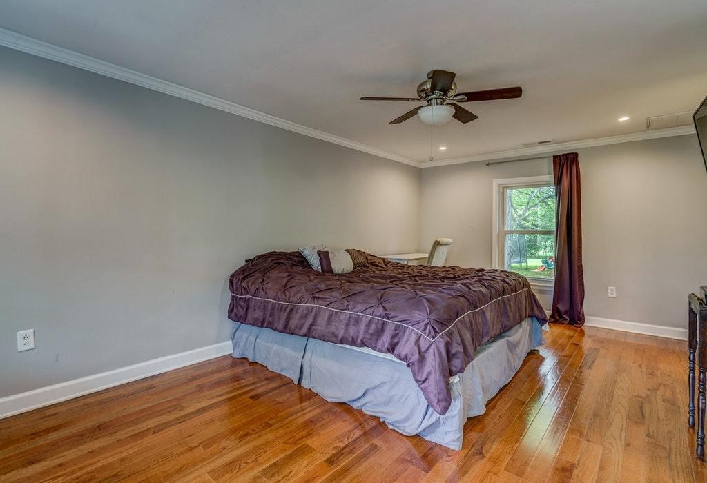 11885 Hardy Road Hardy, VA 24101 - Photo 14 of 48 a spacious bedroom with a bed and a ceiling fan