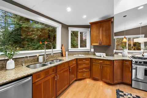 a kitchen with a sink and wooden cabinets