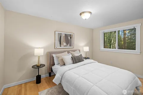 a bedroom with a bed and a lamp