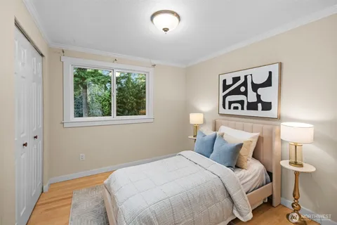 a bedroom with a bed and a painting on the wall