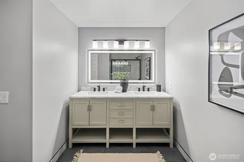 a bathroom with a double vanity sink and mirror
